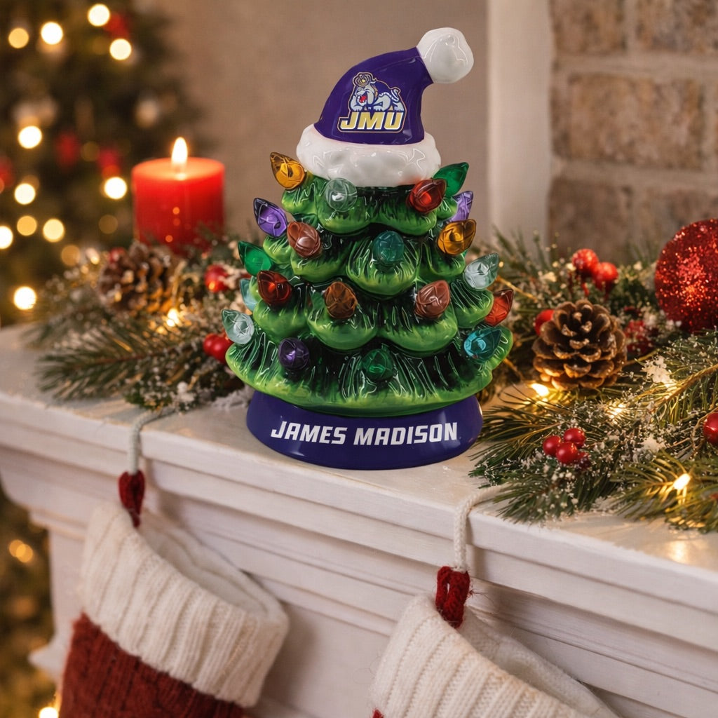 Decorative Christmas tree figurine with a Santa hat on a mantelpiece with festive decorations.