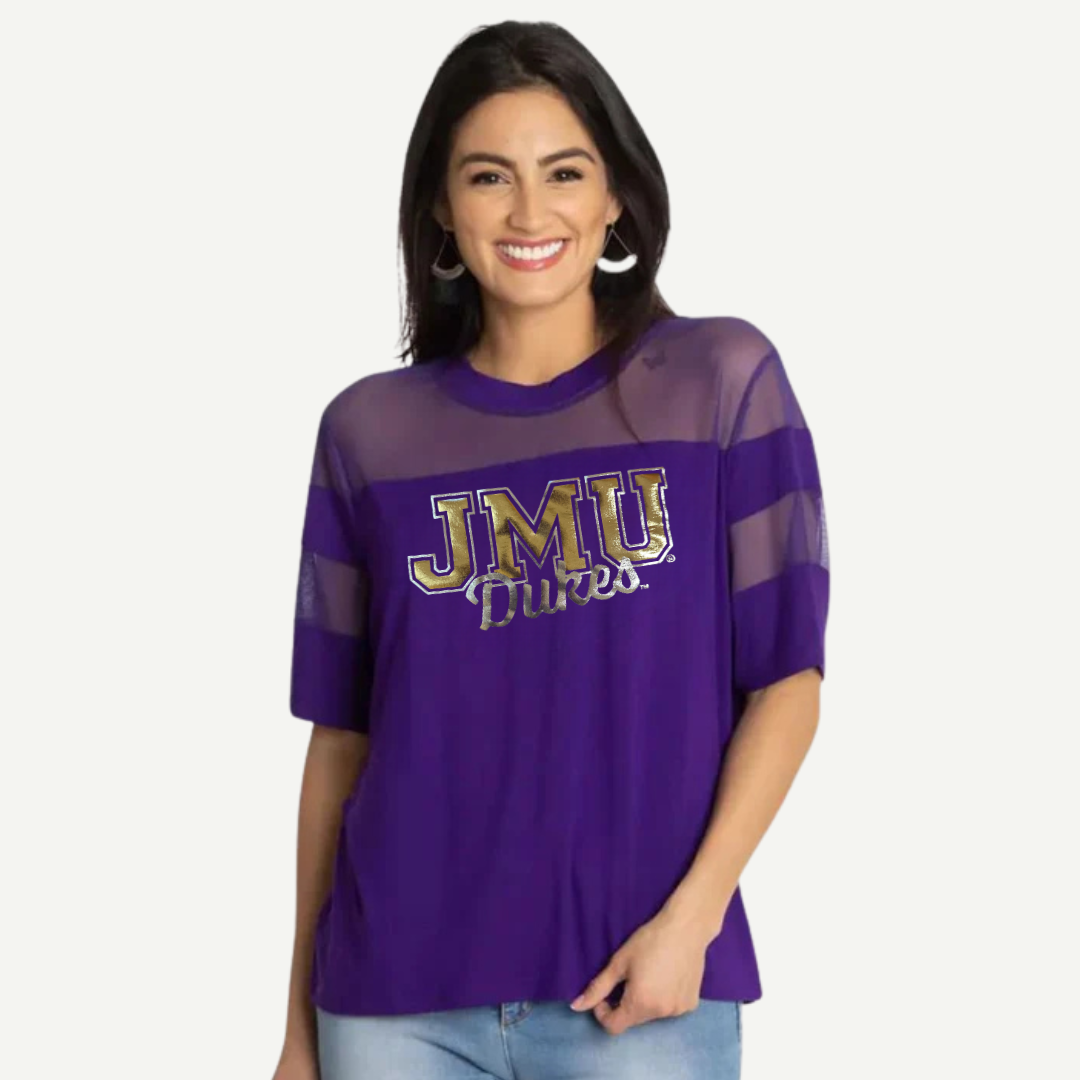 Woman wearing a purple 'JMU Dukes' shirt on a white background