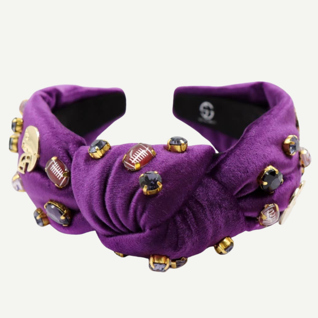Purple slippers with decorative embellishments on a white background