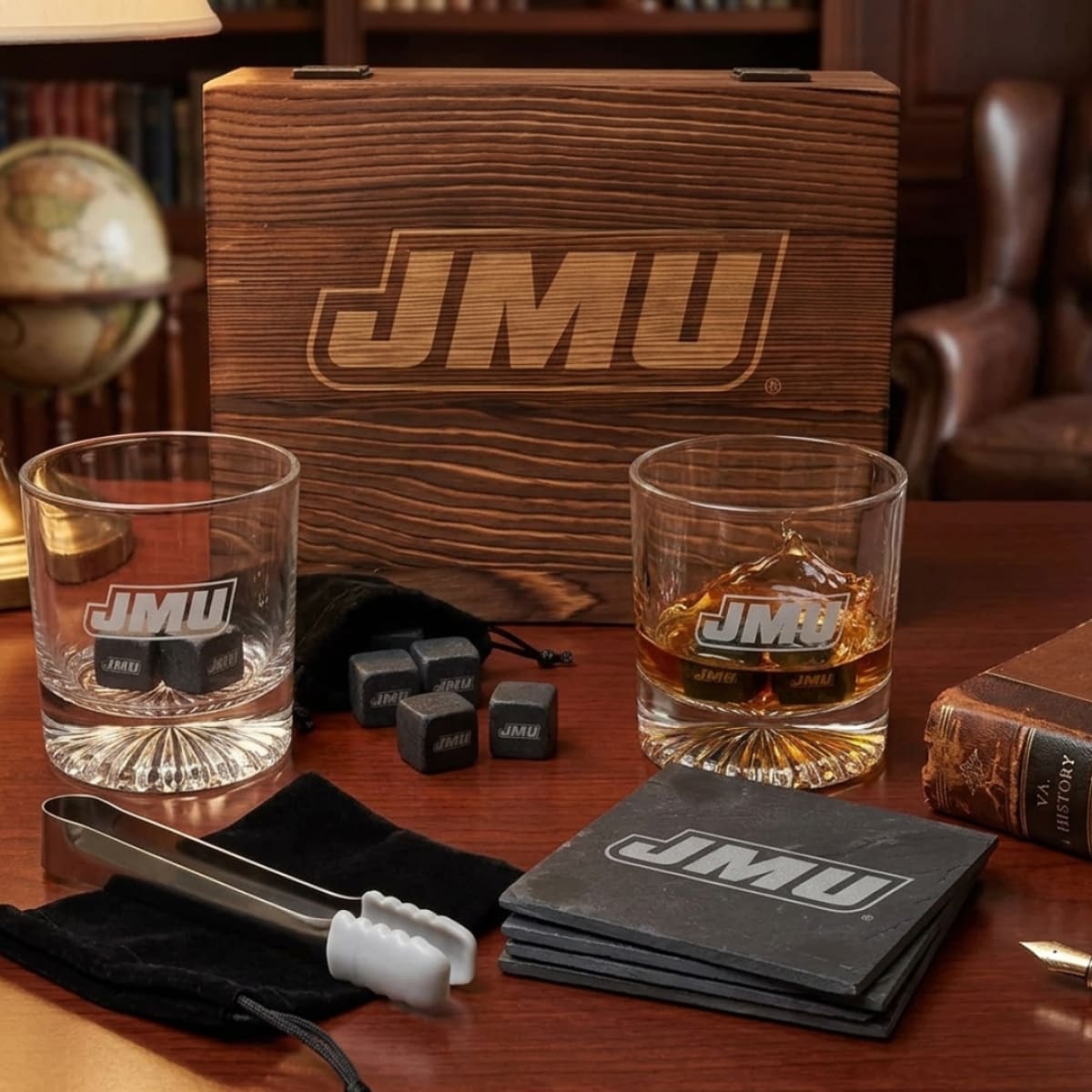 JMU branded glassware and accessories on a wooden table