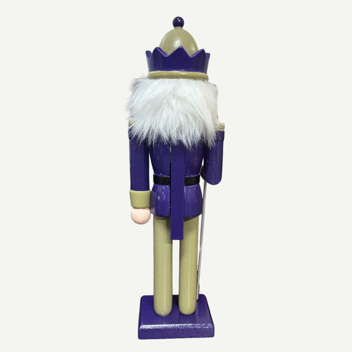Nutcracker figure with a purple outfit and white beard on a white background