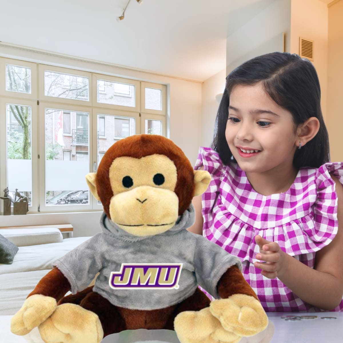 KID PLAYING JMU STUFFED MONKEY TOY