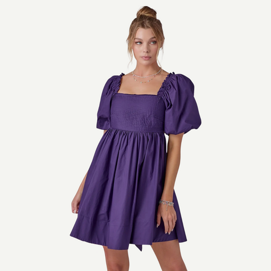 Woman wearing a purple dress on a white background