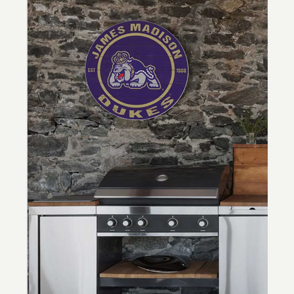 Kitchen with a stone wall featuring the James Madison Dukes logo.