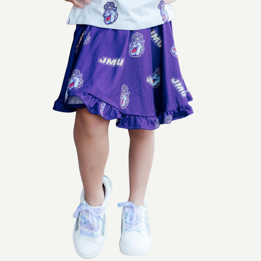 Purple skirt with JMU logo worn by a person on a white background