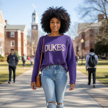 Woman wearing a purple 'DUKES' sweater on a college campus