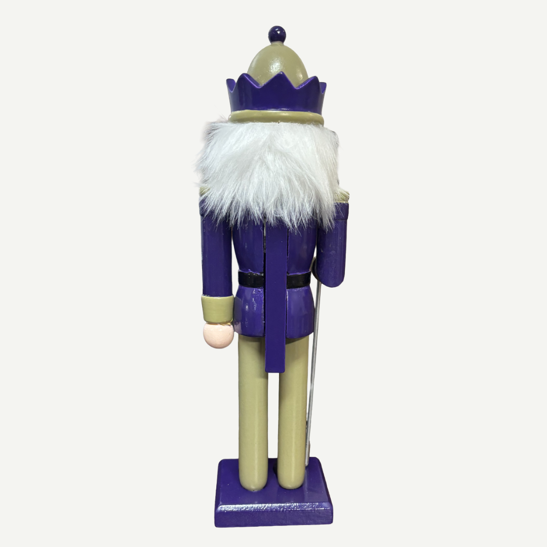 Nutcracker figure with a purple outfit and white beard on a white background