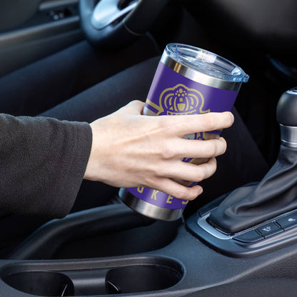 Hand holding a purple tumbler with a logo inside a car.