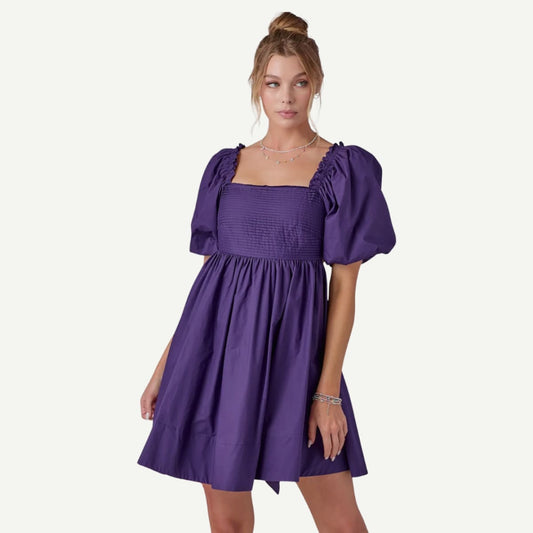 Woman wearing a purple dress on a white background