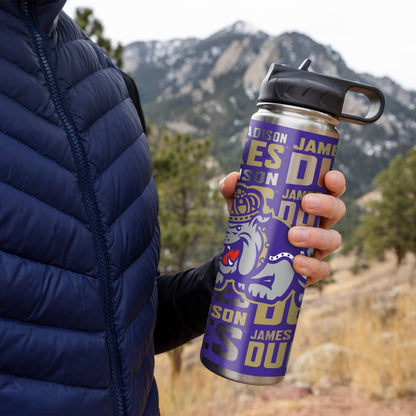 Person holding a purple water bottle with 'Wilson James' branding against a mountainous background