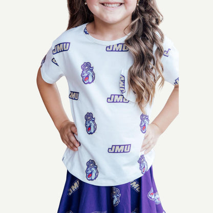 Child wearing a white t-shirt with JMU logos and a purple skirt on a white background