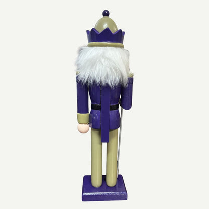 Nutcracker figure with a purple outfit and white beard on a white background