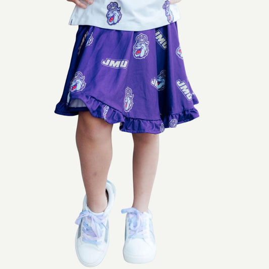 Purple skirt with JMU logo worn by a person on a white background