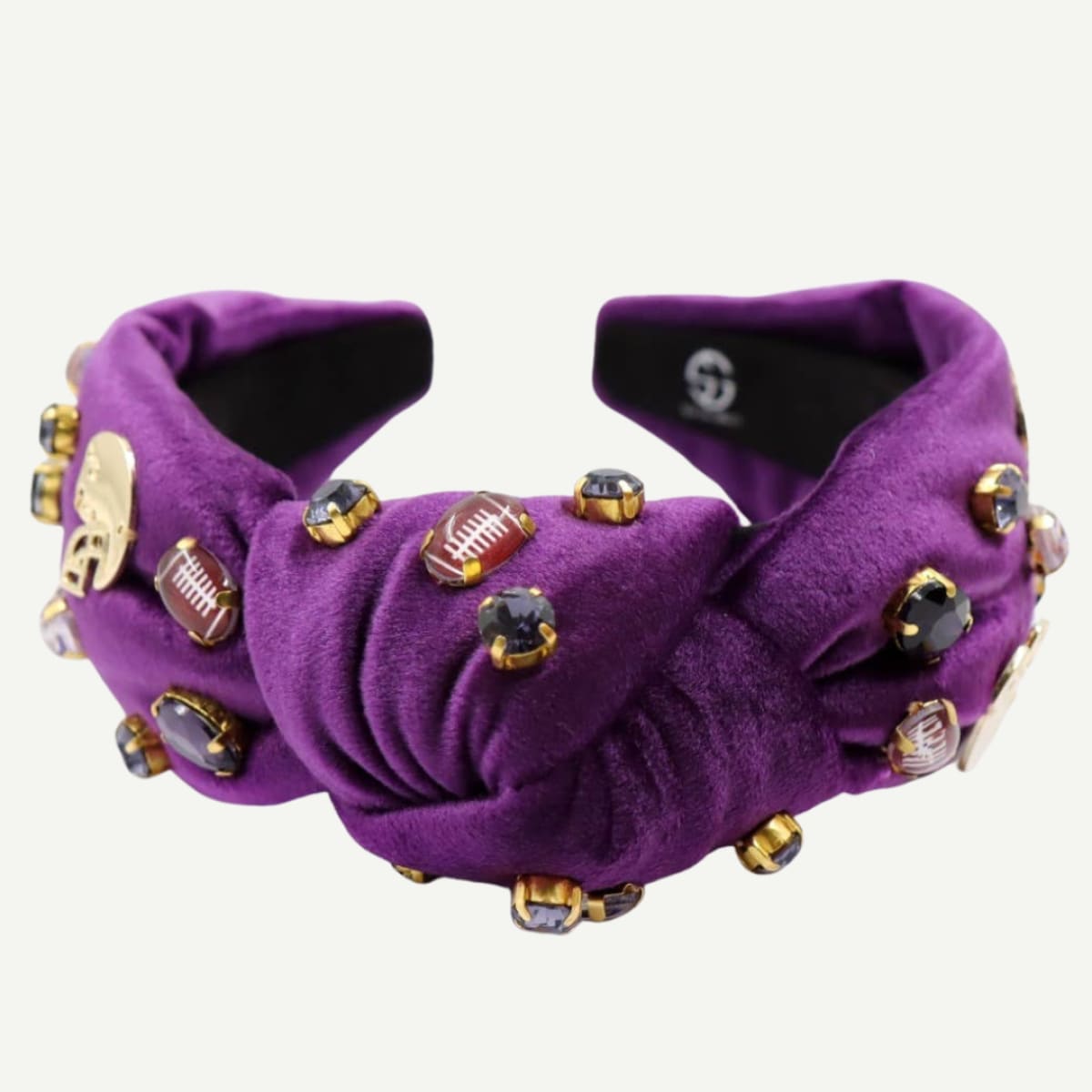 Purple slippers with decorative embellishments on a white background